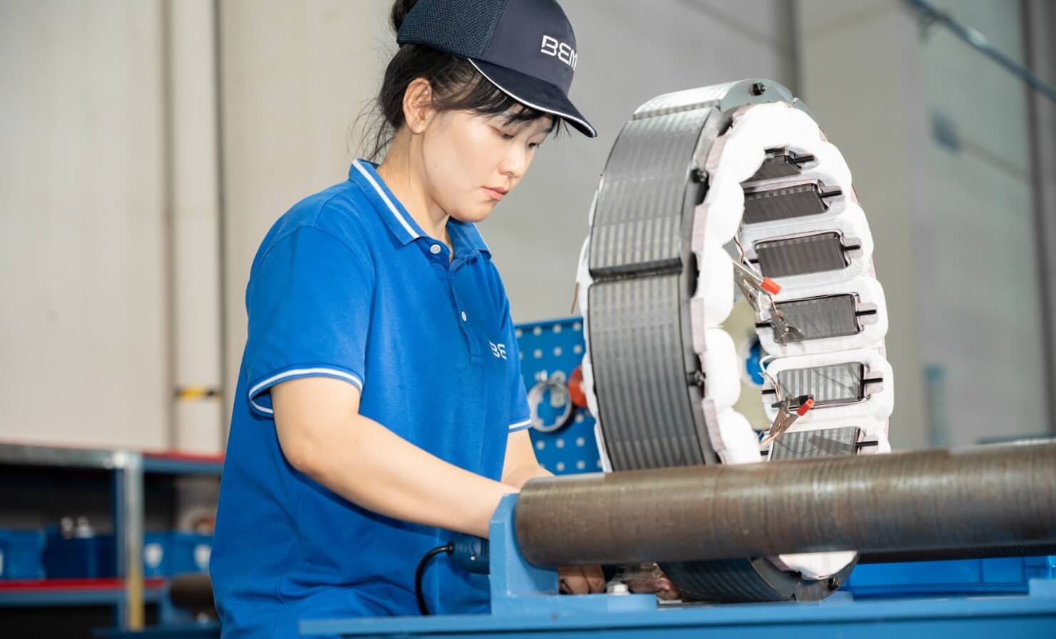 Woman working an a big spool