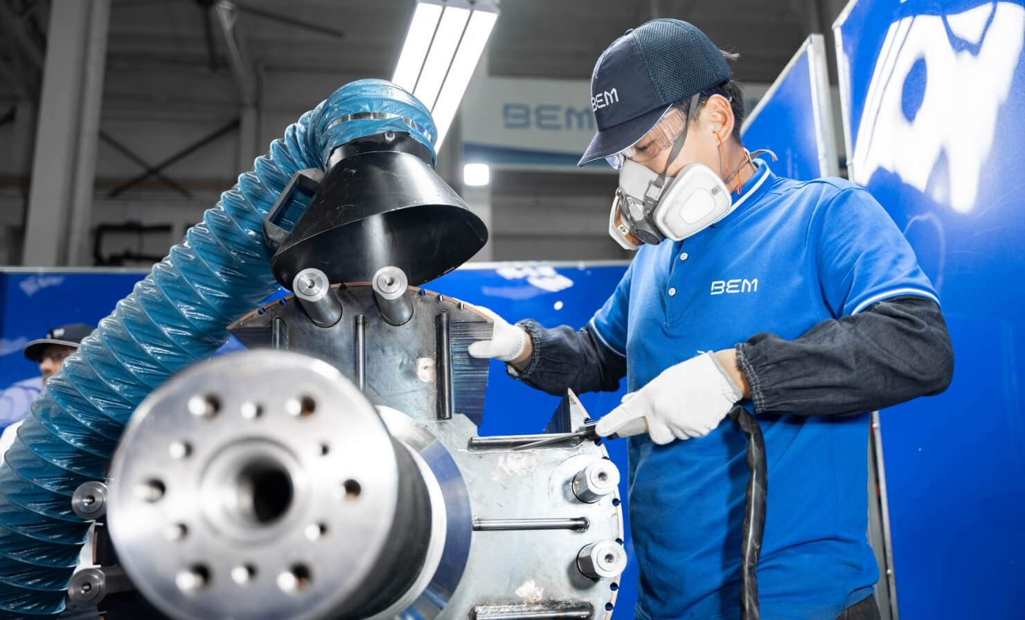 Man cleaning a big machine part