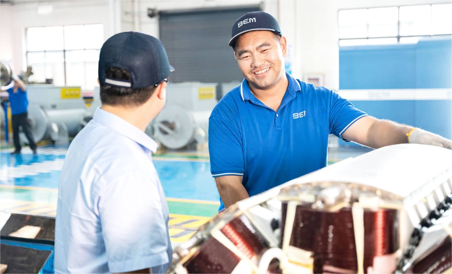 2 workers - one is smiling to the other one